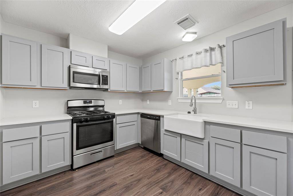 Richly painted cabinets provide a clean and timeless look, enhancing the sense of brightness and openness in the space.