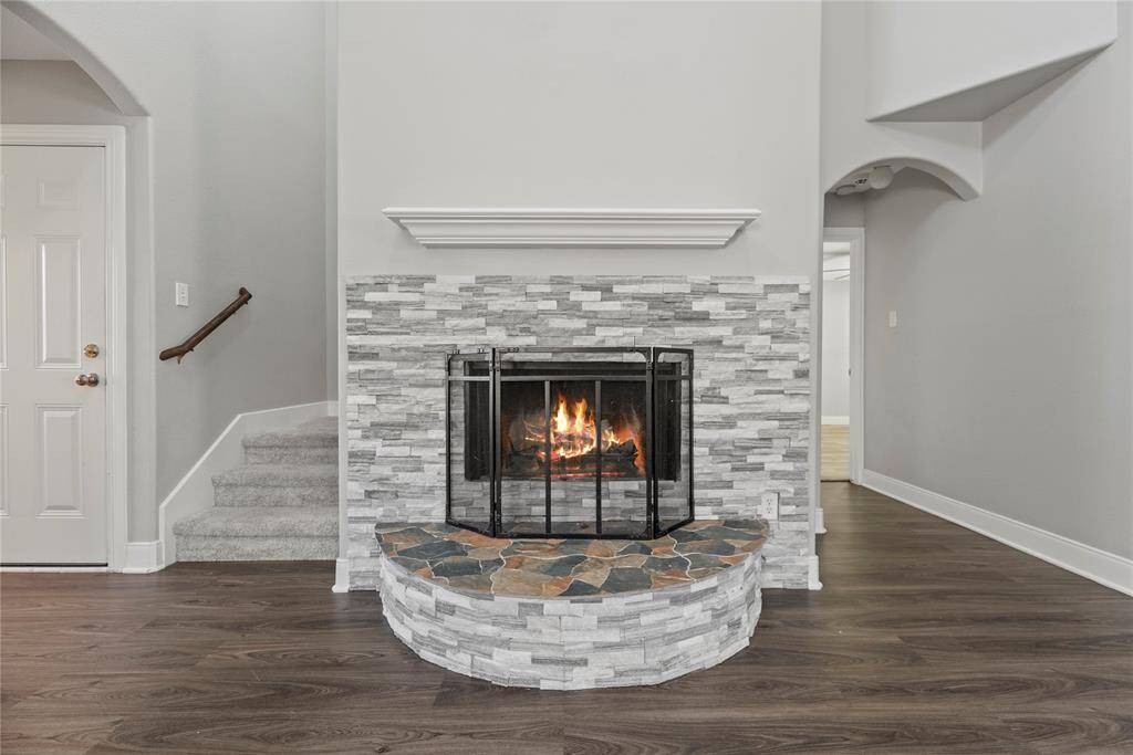 This inviting center fireplace becomes a focal point that anchors the room and invites people to gather and linger, making it a cherished feature of the living area.