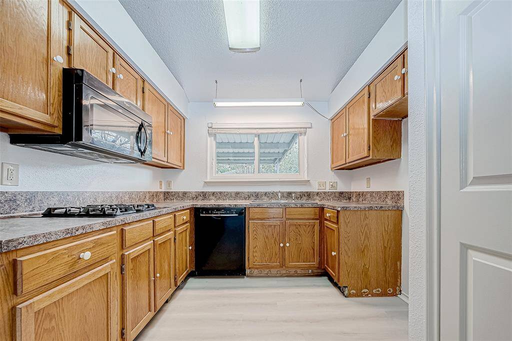 Kitchen overlooks covered back yard and patio