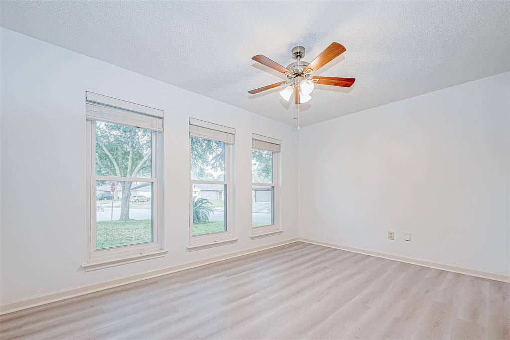 Guest bedroom with walk in closet and large windows