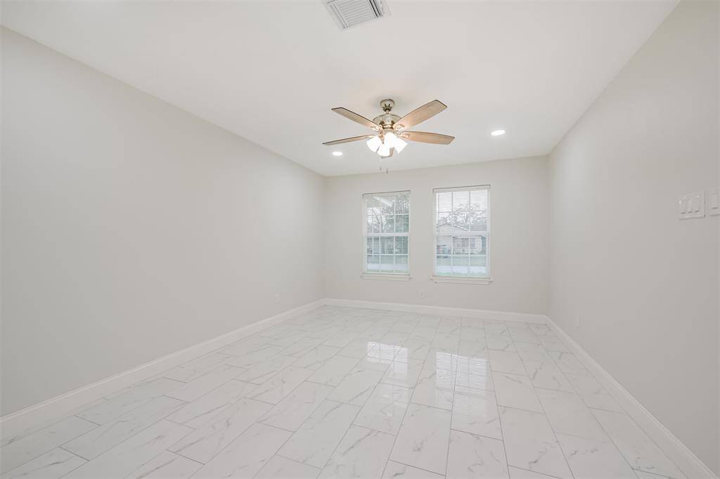 Experience a modern and inviting living space with stunning tile flooring, fresh paint, and ample natural light. Perfect for relaxing or entertaining.