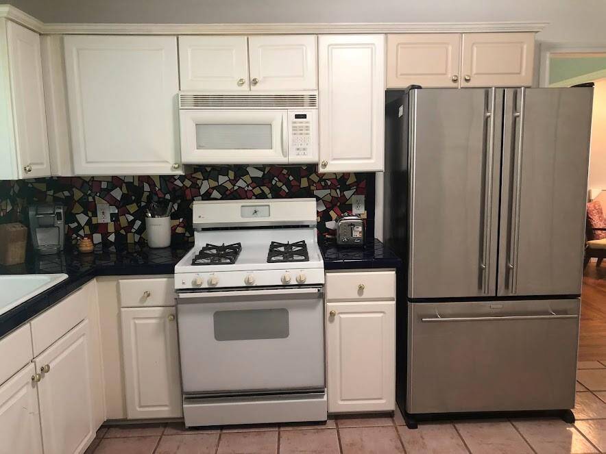 THE KITCHEN HAS GAS STOVE W/ OVEN, BUILT-IN MICROWAVE AND STAINLESS STEE FRENCH DOOR REFRIGERATOR