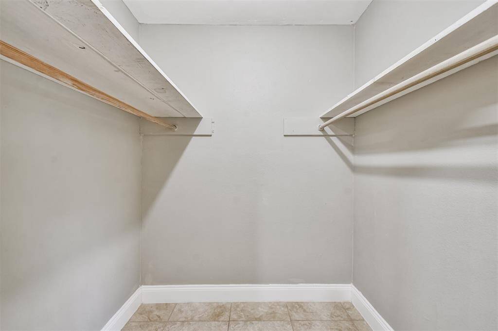 Spacious walk-in closet with ample shelving and hanging space for all your wardrobe needs.