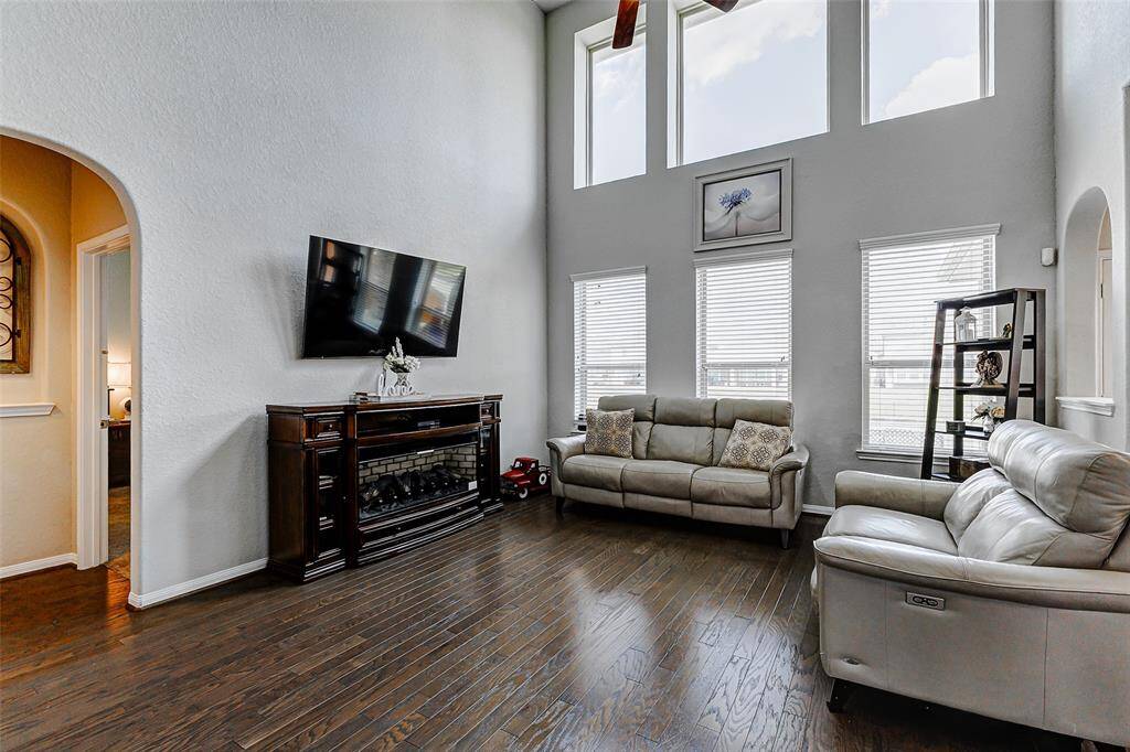 Imagine a spacious living room bathed in natural light streaming through expansive windows that offer breathtaking panoramic views of a serene lake.