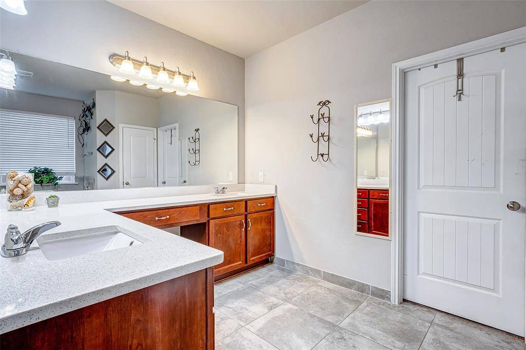 This spacious primary bathroom boasts a luxurious design, highlighted by separate double sinks.