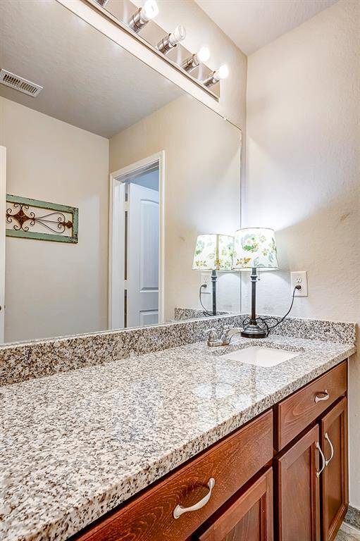 Full bathroom with granite tops for easy cleaning .