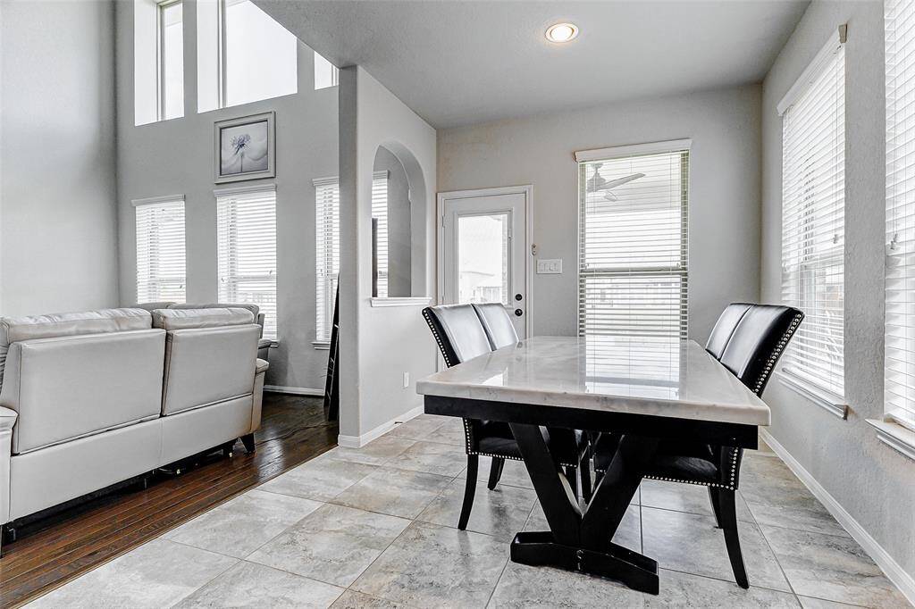 Imagine a bright and airy breakfast nook situated adjacent to the living room, with large windows.