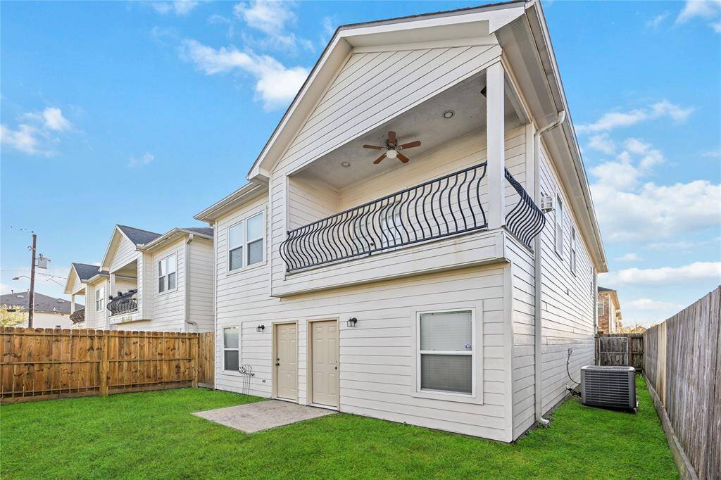 Fenced backyard, a covered balcony with a ceiling fan, and an outdoor patio space.