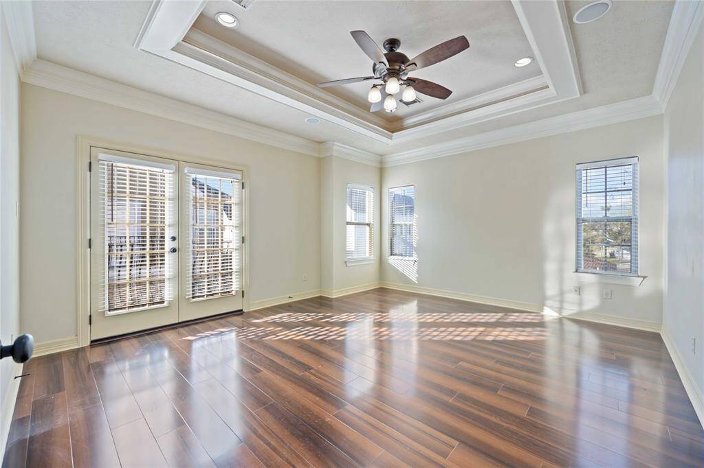 Bright breakfast area with tiled flooring and neutral walls. It features crown molding, a stylish chandelier, and large windows that let in natural light. Perfect for intimate gatherings.