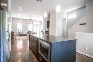 Microwave is built into the island.  There is a 1/2 Bath across from the stairs.