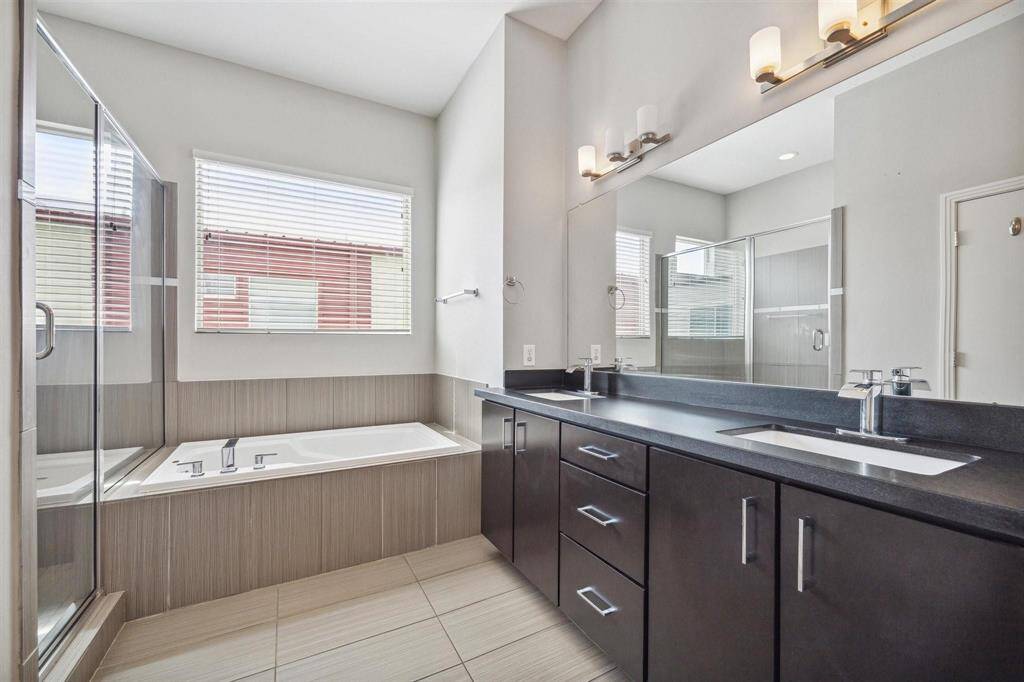 Primary ensuite has double sinks, soaking tub and walk in shower.  Great tile, sleek contemporary design and lots of light.
