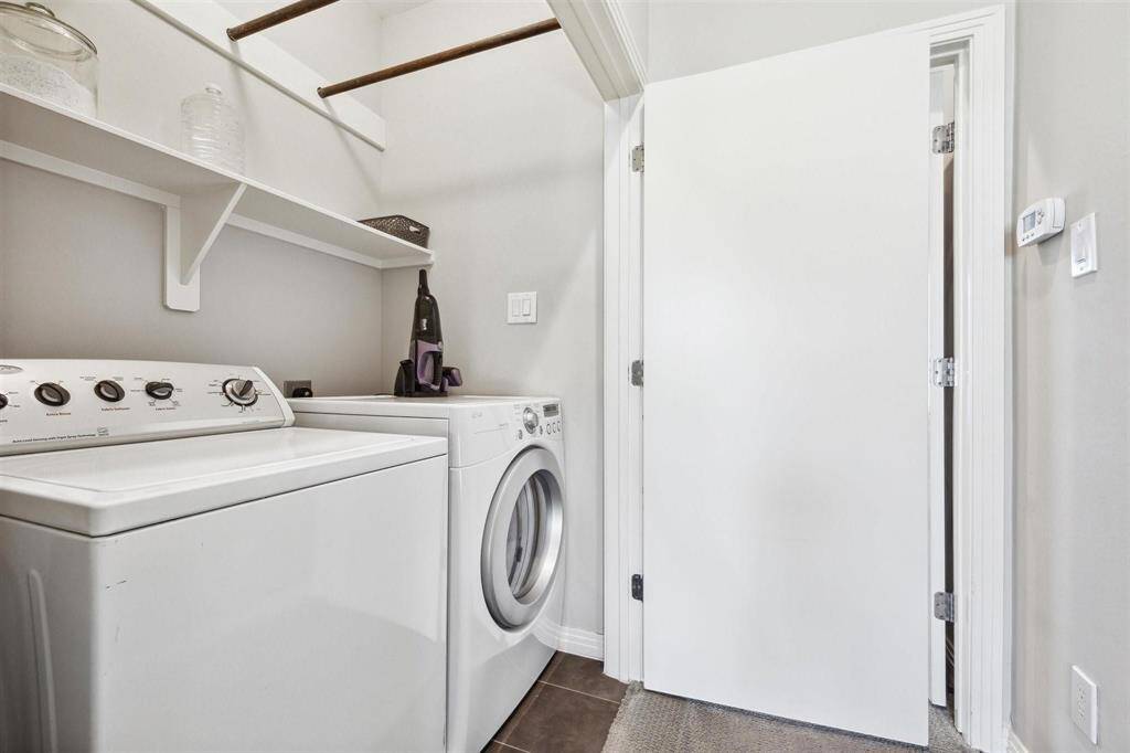 Laundry room with hanging area and shelving.  WASHER / DRYER INCLUDED