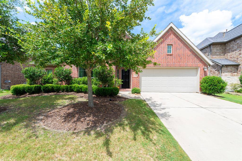 Beautiful landscaping welcomes you to this fabulous home giving you a hint of the treasures you will find inside. Note, the flooring throughout the first floor is tile and hardwood--only carpeting is in the upstairs gameroom and the primary bedroom closets.