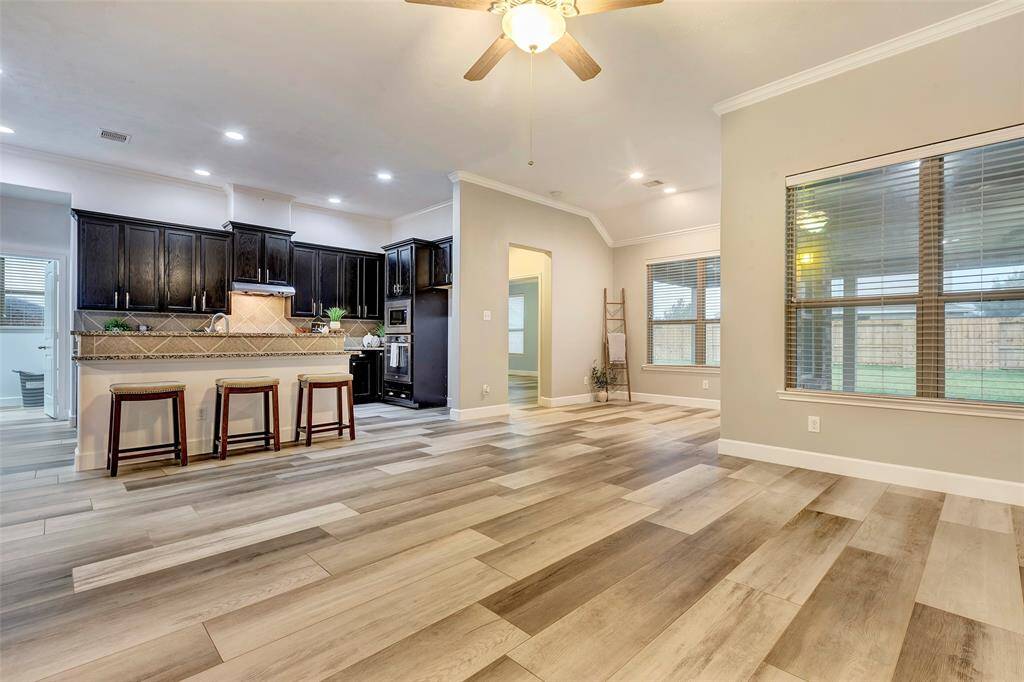 The open-concept floorplan seamlessly connects the kitchen, breakfast area and family room. And those stunning floors tie it all together so beautifully!