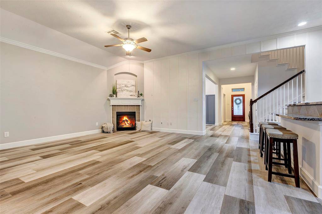 Open to the kitchen, the family room offers seamless flow, making it ideal for entertaining. Enjoy the warmth of the gas-burning fireplace and the beauty of the modern finishes.