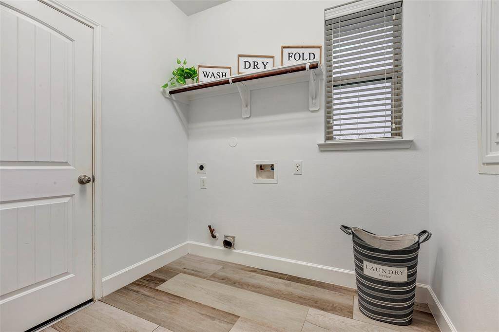 The first-floor laundry room is generously sized, with both electric and gas connections for added convenience. The door shown provides access to the 3-car garage.
