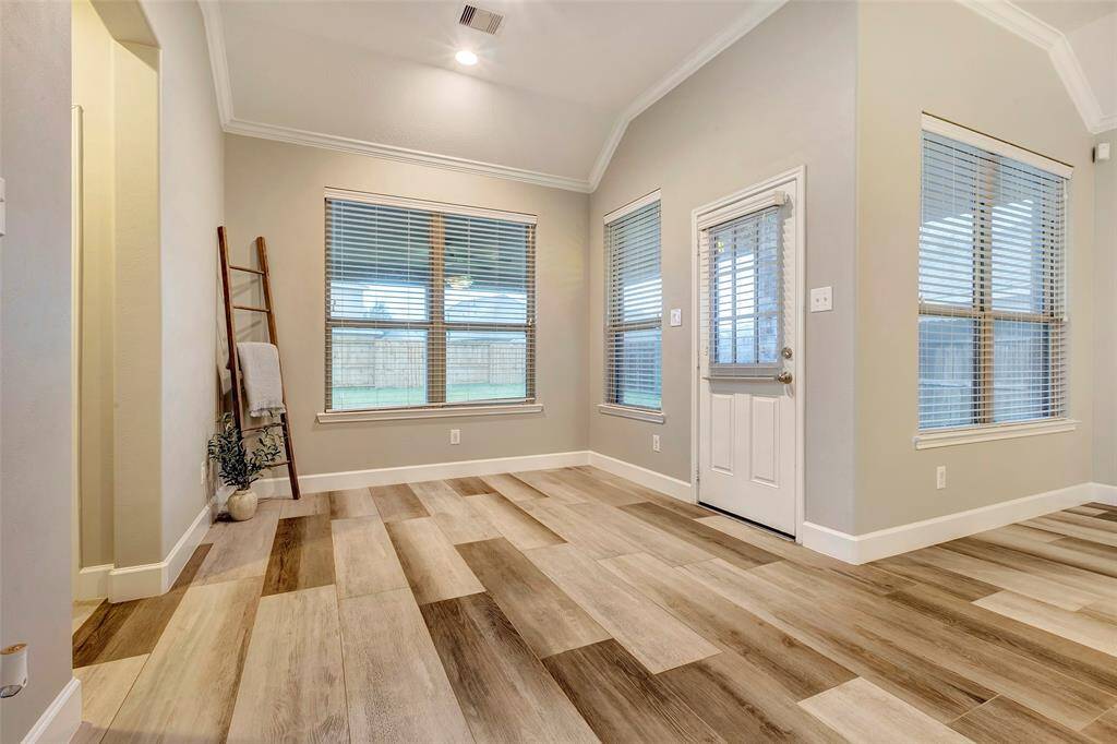 Conveniently located between the kitchen and patio, this bright and inviting space is ideal for everyday meals, all while showcasing the beautiful flooring, tall ceilings and neutral paint color.