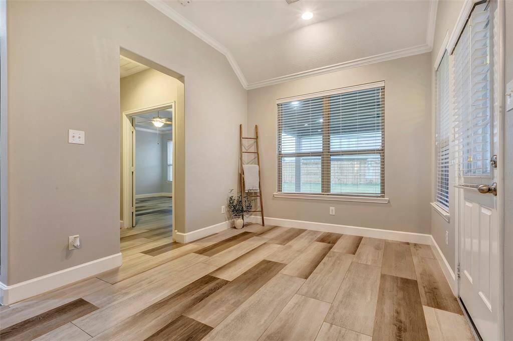 Step through the elegant archway and double doors entry to access the impressive first-floor primary suite.