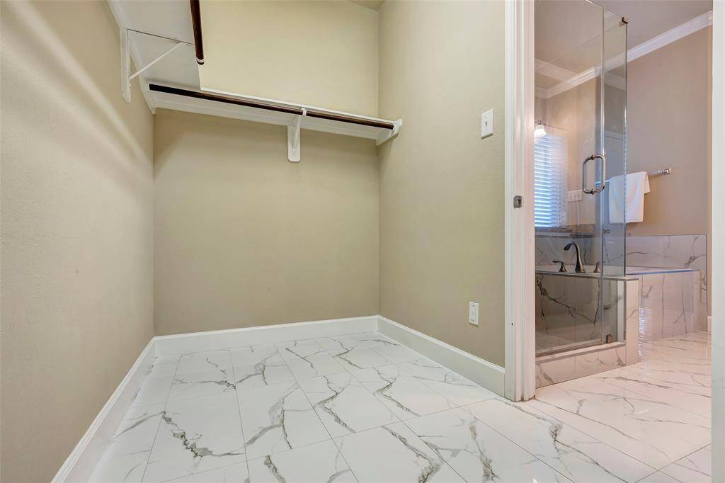 The large, walk-in closet in the primary bedroom suite has been upgraded with the beautiful new flooring, as well.