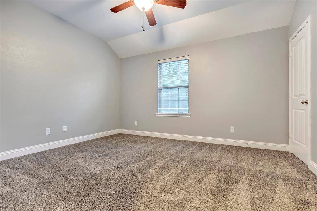 Bedroom #2 is generously sized with a walk-in closet, a ceiling fan, newer carpet and peaceful views of the front yard.