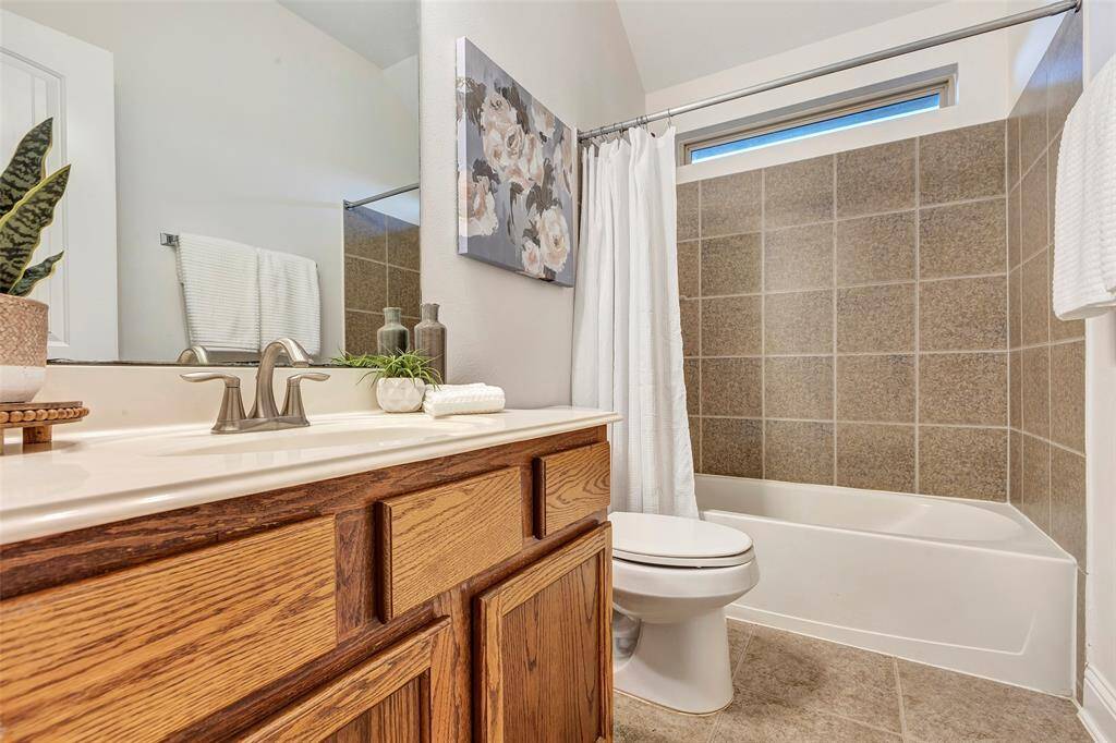 This full bath next door to bedroom #2 provides great storage and amenities for family members or guests.
