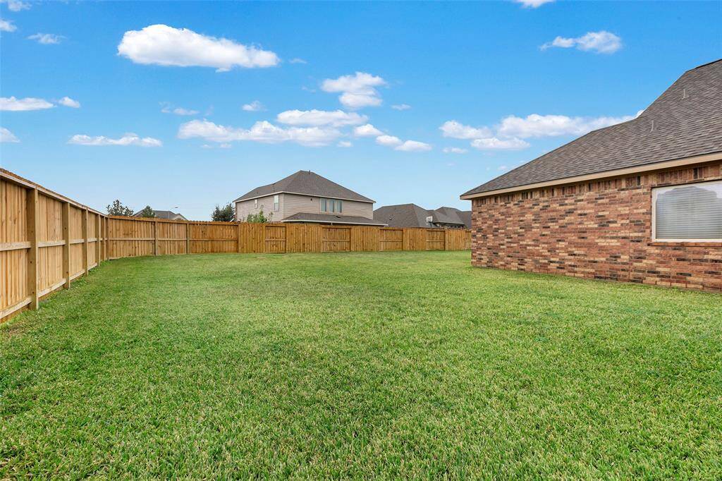 The L-shaped backyard is spacious and perfect for endless outdoor possibilities! And the sellers recently replaced two sections of the large, wooden fence.