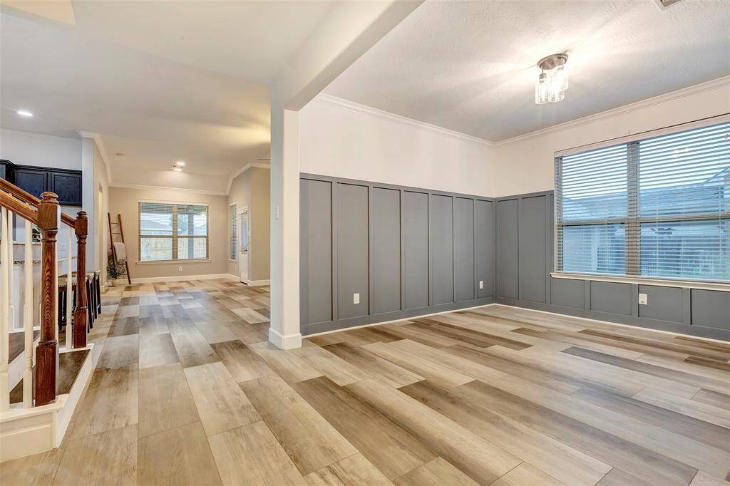 This home is designed for entertaining, with a formal dining room enhanced by decorative molding, custom paint, and an updated chandelier that is on a dimmer switch so you can control the lighting and ambience.