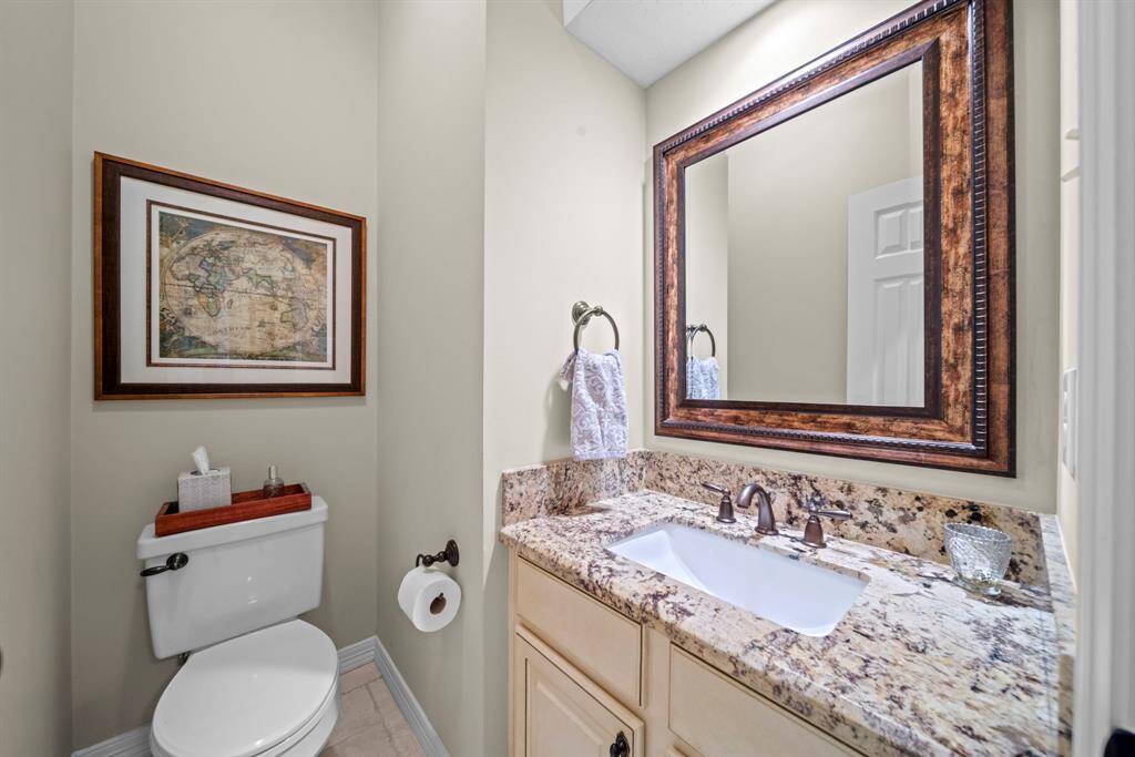 Half bathroom downstairs with upgraded countertops and mirror!