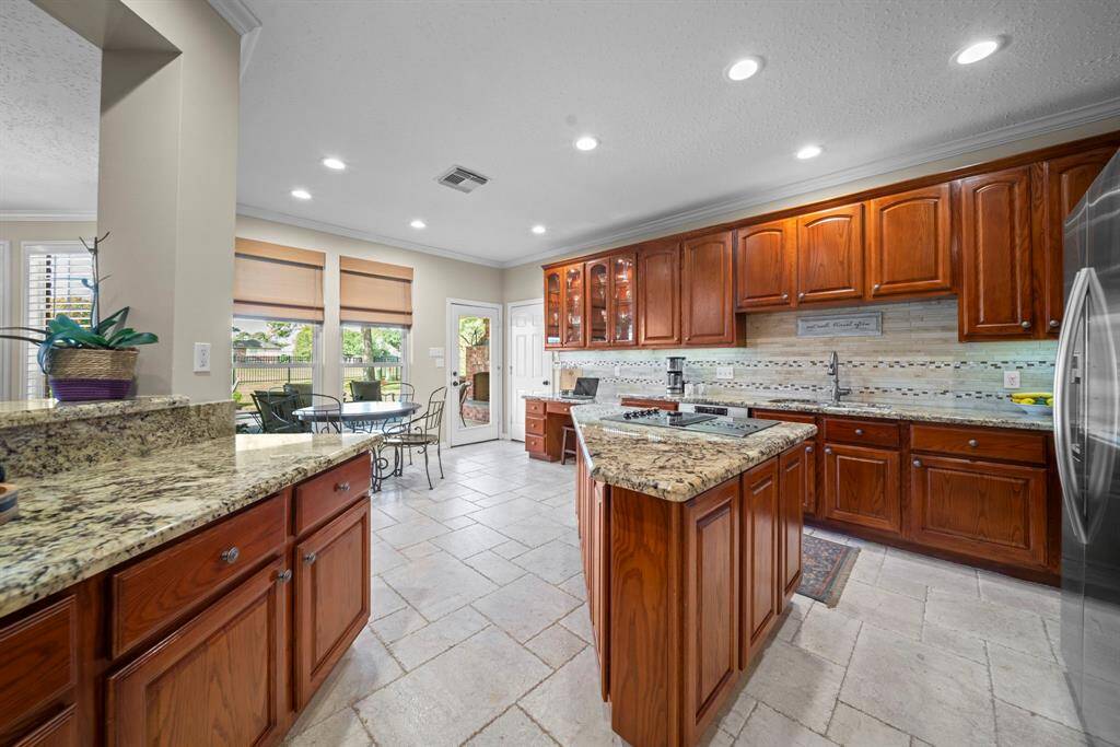 This kitchen features plenty of countertop space, cabinetry and additional storage space in the island!