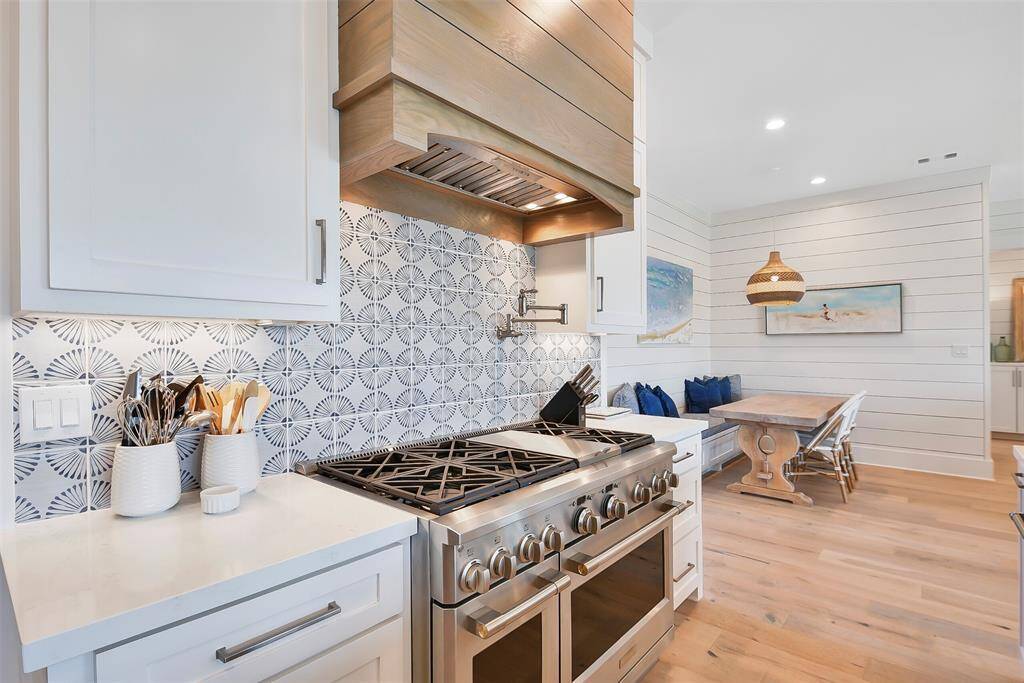 Chef's kitchen with Monogram gas range and pot filler