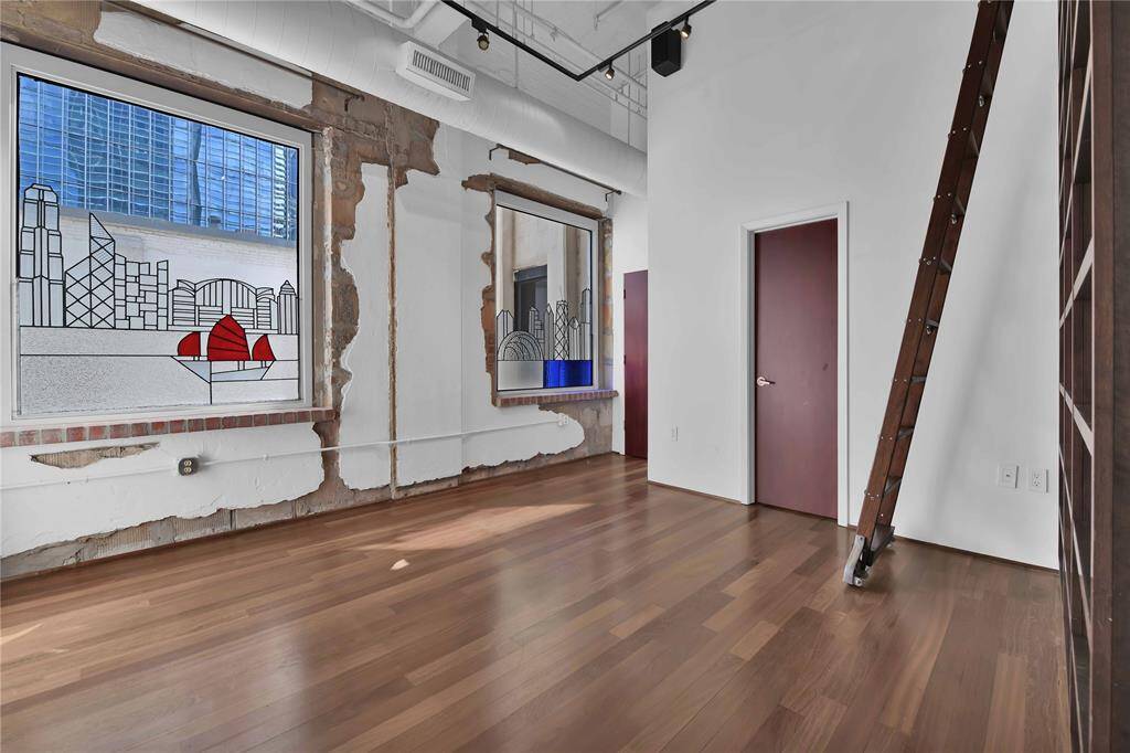 Second bedroom doubles as a beautiful library. Stained glass inserts to windows are current owners  previous home cities, Hong Kong and Chicago. Currently excluded from sale.