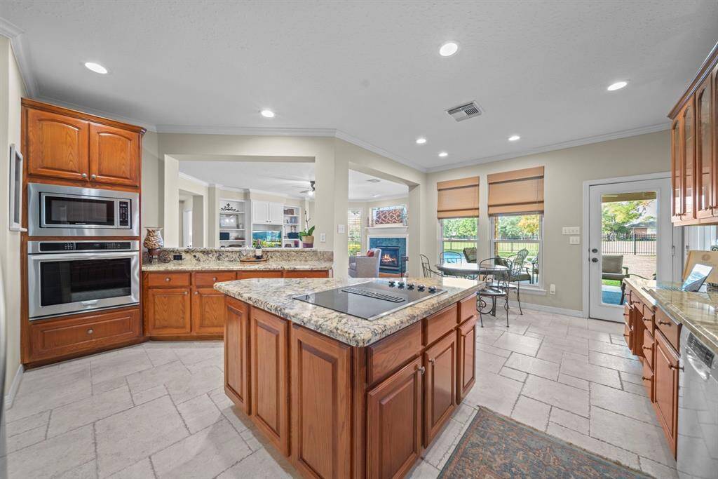 Enjoy modern stainless steel appliances, including a Bosch dishwasher and KitchenAid microwave, oven, and electric cooktop, with the added convenience of gas connections available in the island!