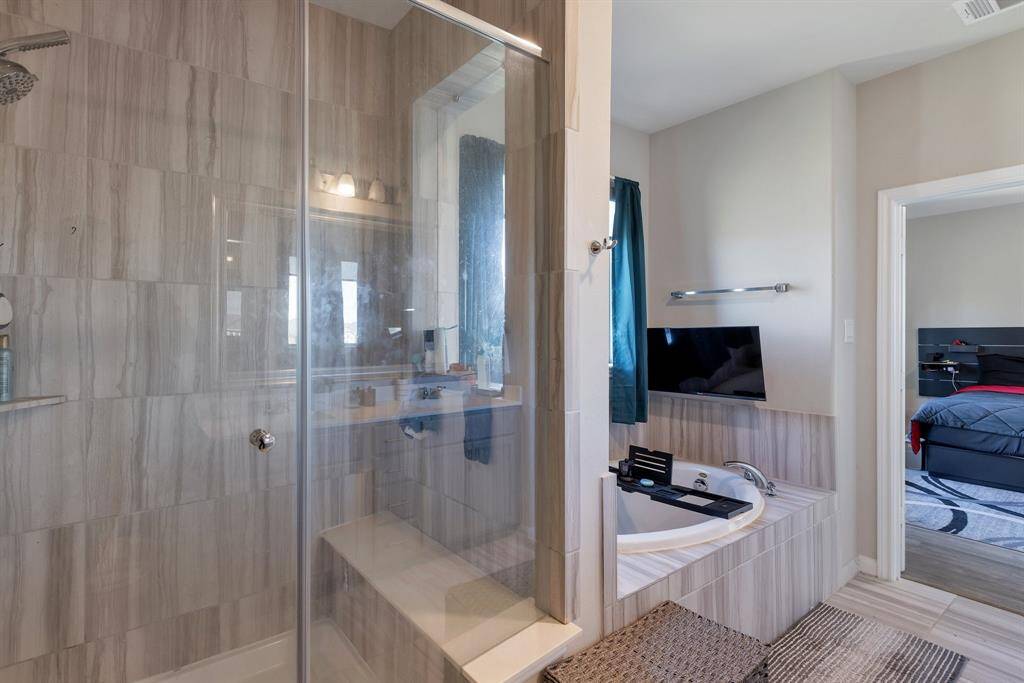 View of the master bath with the large shower with a seat.