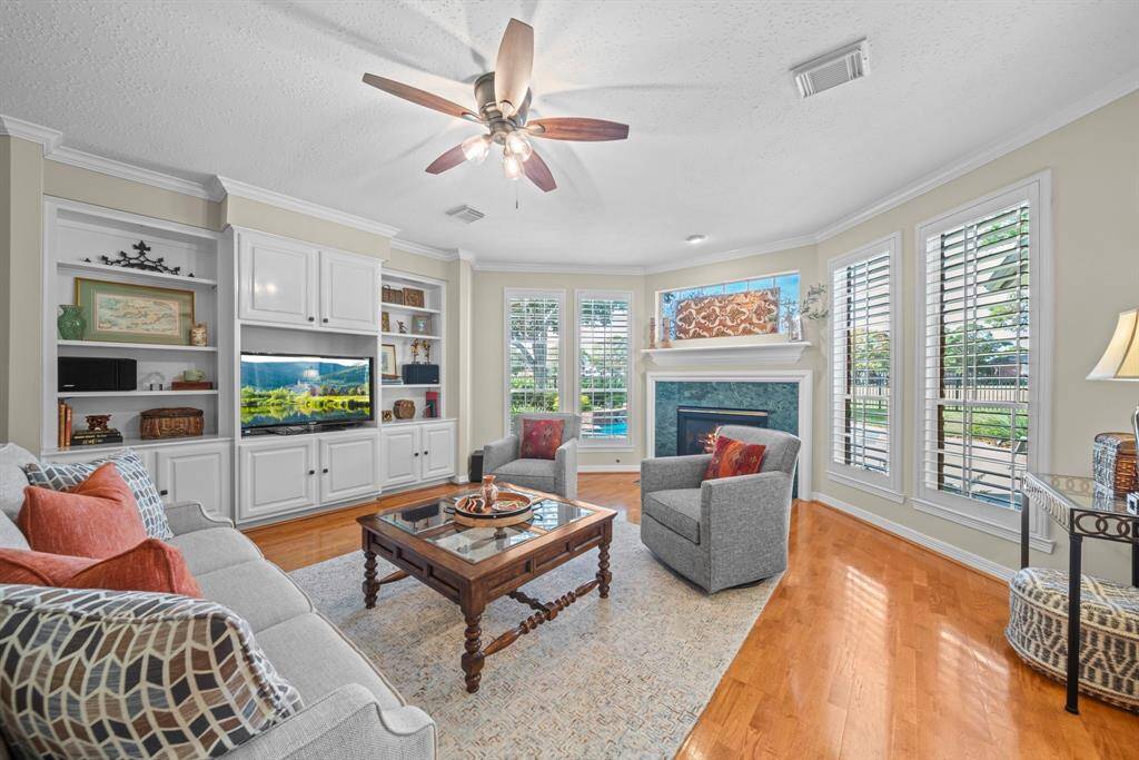 The living area is light and bright, with a grand view of the pool and golf course!