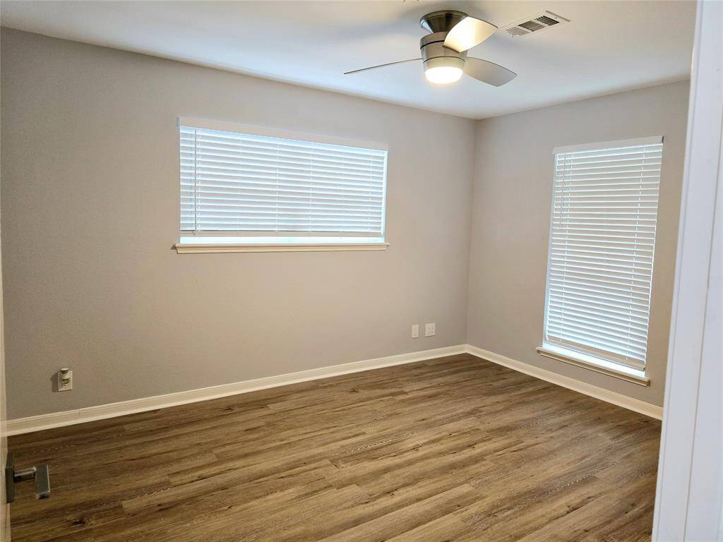 The third bedroom features two large windows that flood the area with natural light.  New blinds, new floor, new ceiling fan w/light fixture.