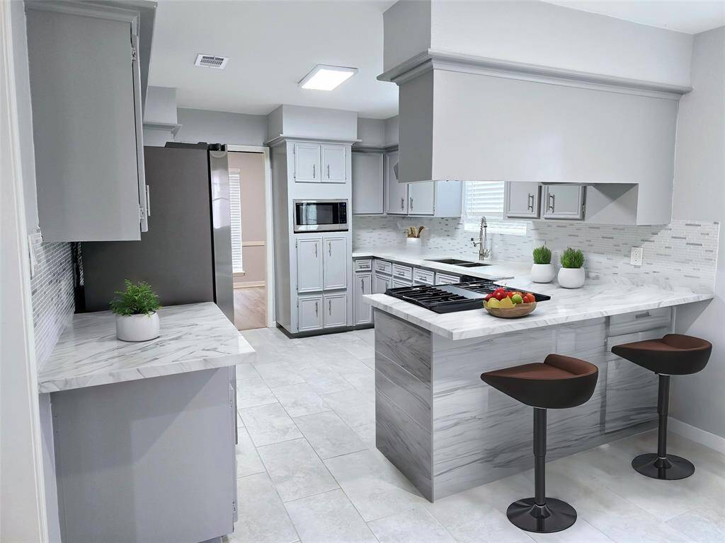 The updated kitchen has an open design conducive to entertaining.