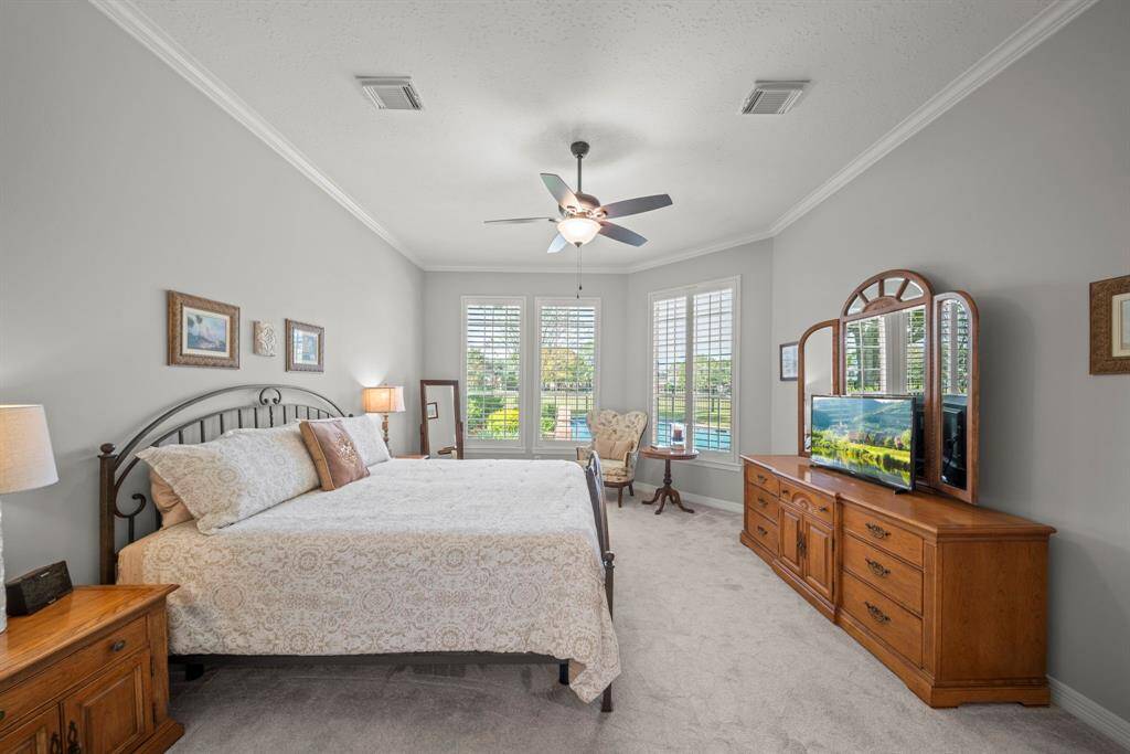The primary has a delightful view of your backyard oasis!