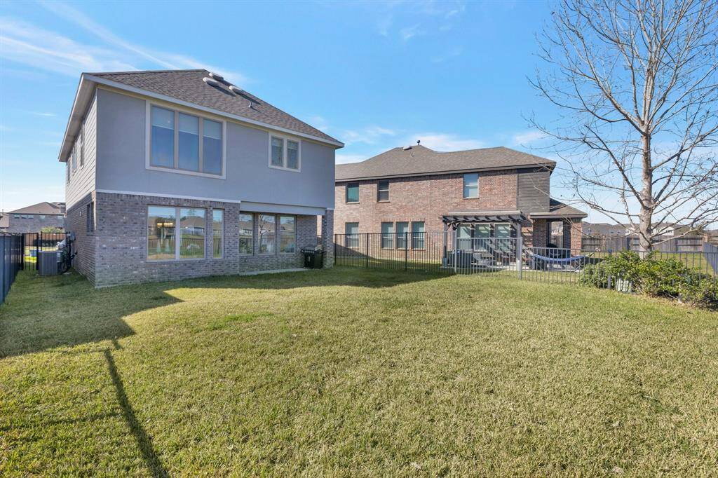 View from the fence of the back of the home. Master bedroom is on the left of the second story here. No wood fences to replace here either!!
