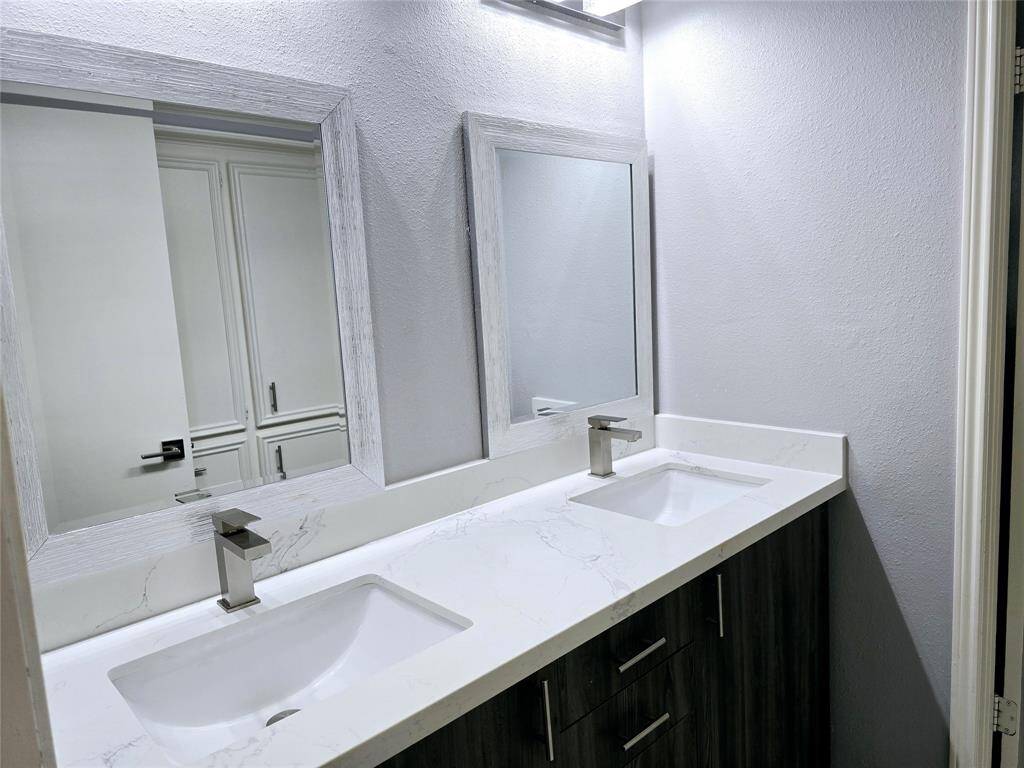Double new mirrors and modern lighting completes this second bathroom.