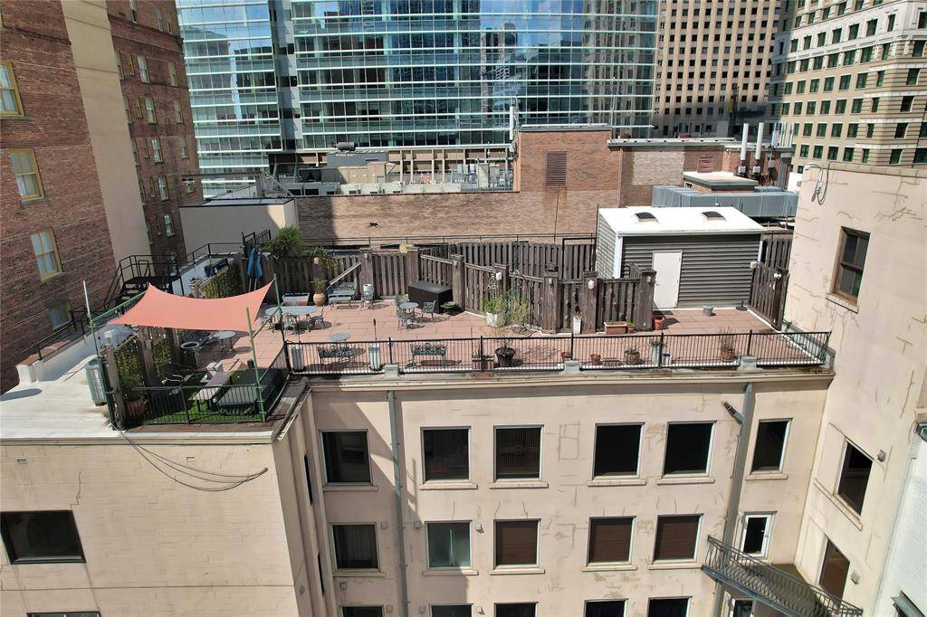 Top row of windows are of the penthouse. Almost 1100 sq ft private terrace shown with reddish concrete tile patio.