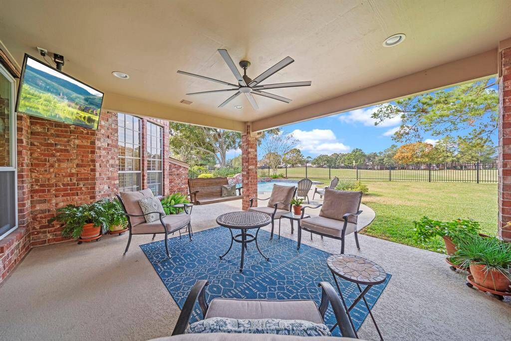 Covered back patio with a new 65" outdoor ceiling fan with remote control!
