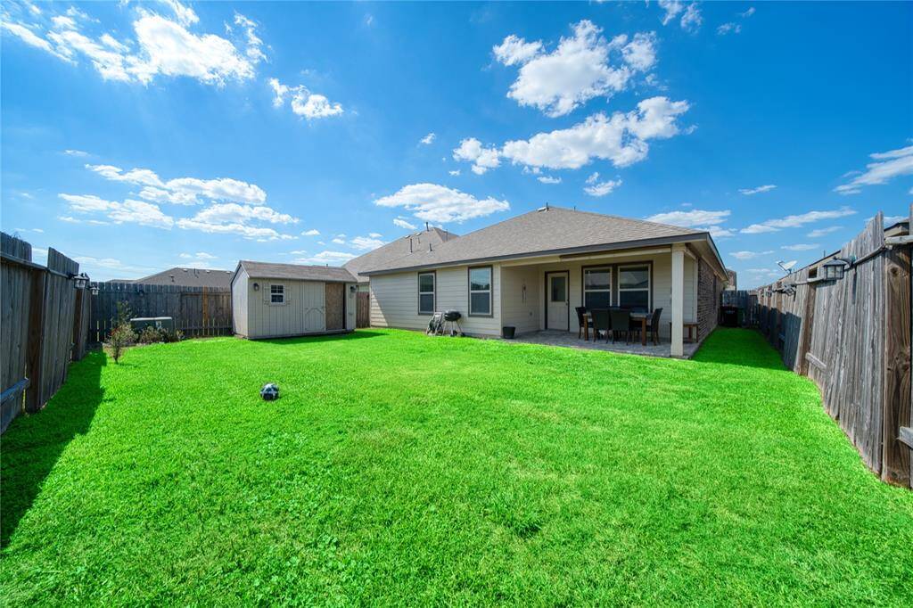 Storage shed included.