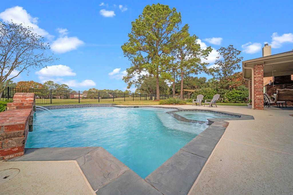 A 30' x 20', 17,000-gallon saltwater pool with an attached spa, featuring automatic water fill, overflow system, aerators, and three elegant sconce water features.