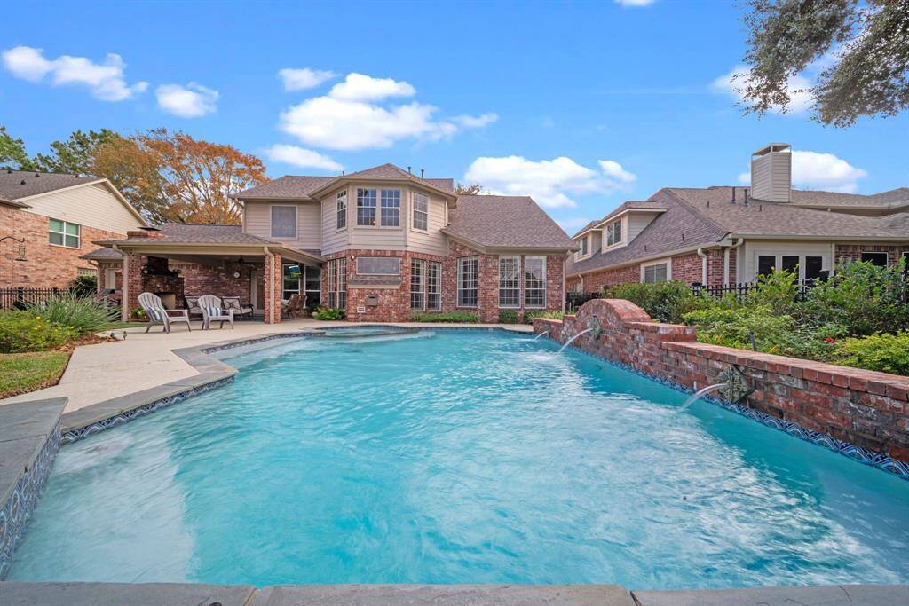 Surrounded by a resurfaced pool deck & serene landscaping!