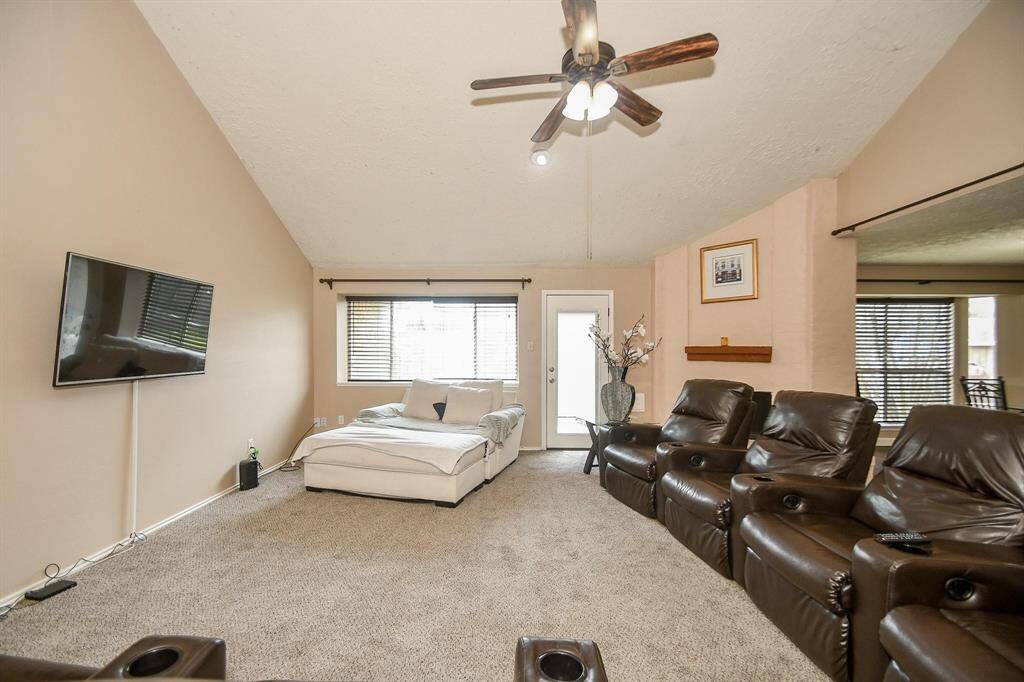 Spacious and inviting living room with vaulted ceilings, abundant natural light, and perfect for relaxing or entertaining.