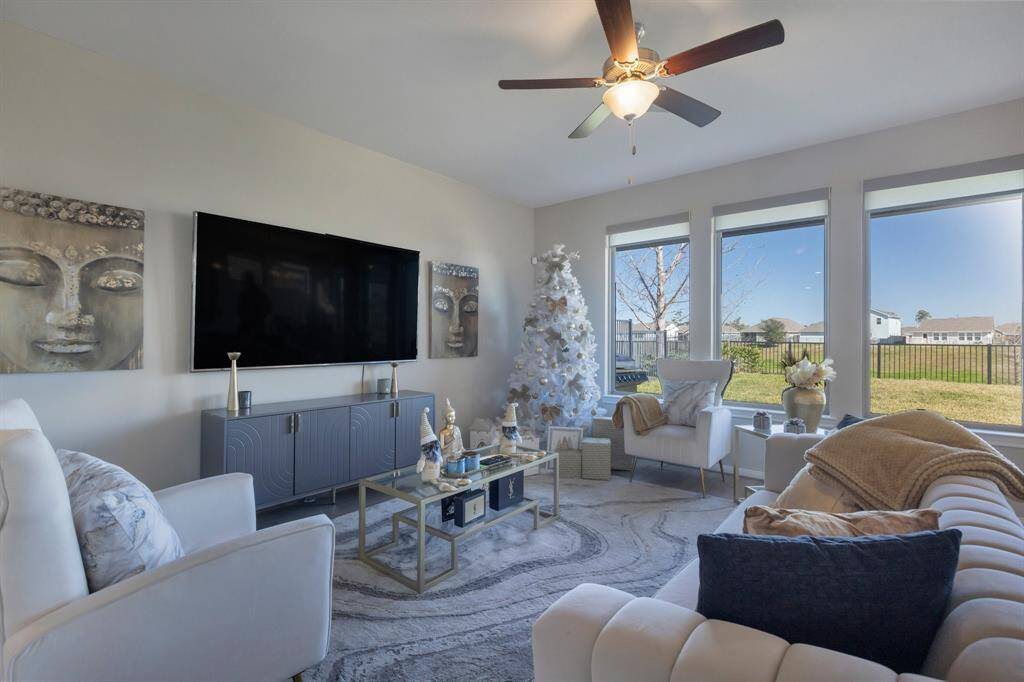 The family room has great views through the wall of windows to the back yard. Just over the fence is a large lake with fountains, ducks, cranes and other wildlife to watch.