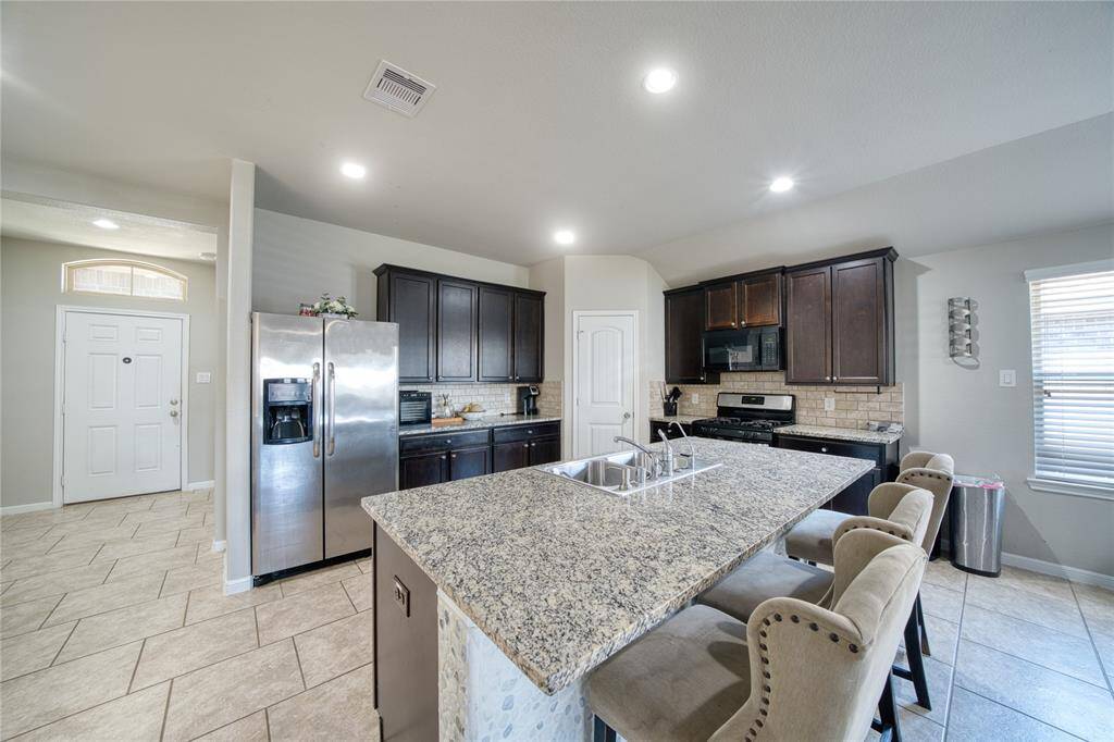 Beautiful Granite countertops in this open concept kitchen.