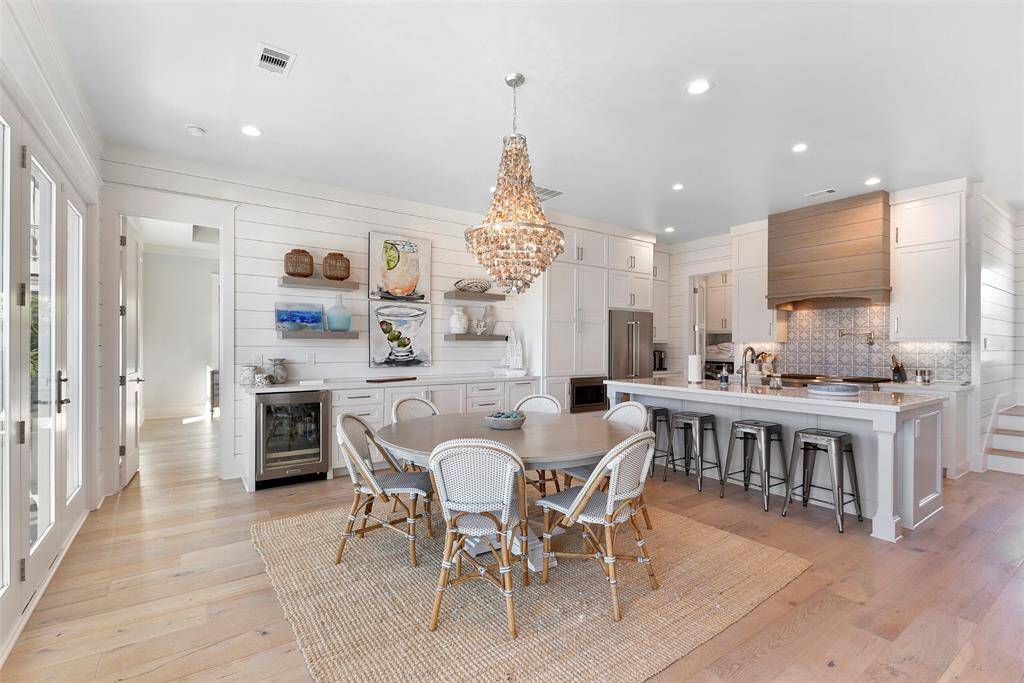 View of kitchen/dining combo with large dry bar and wine refrigerator