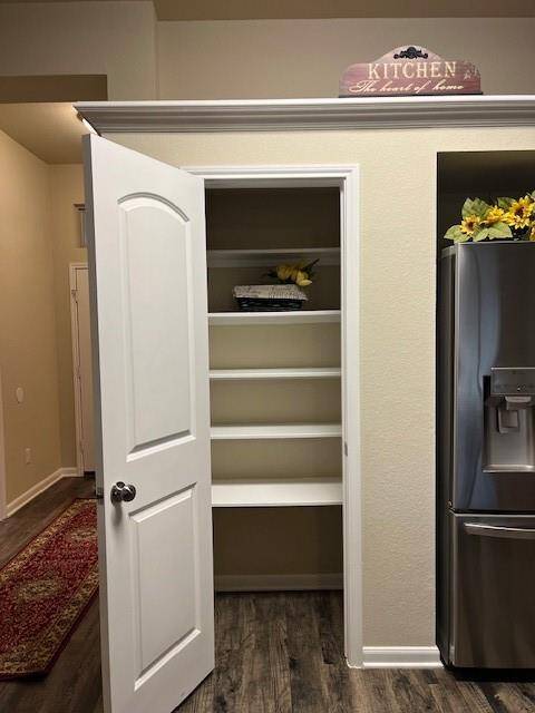 Nice size pantry with built-in wood shelves!