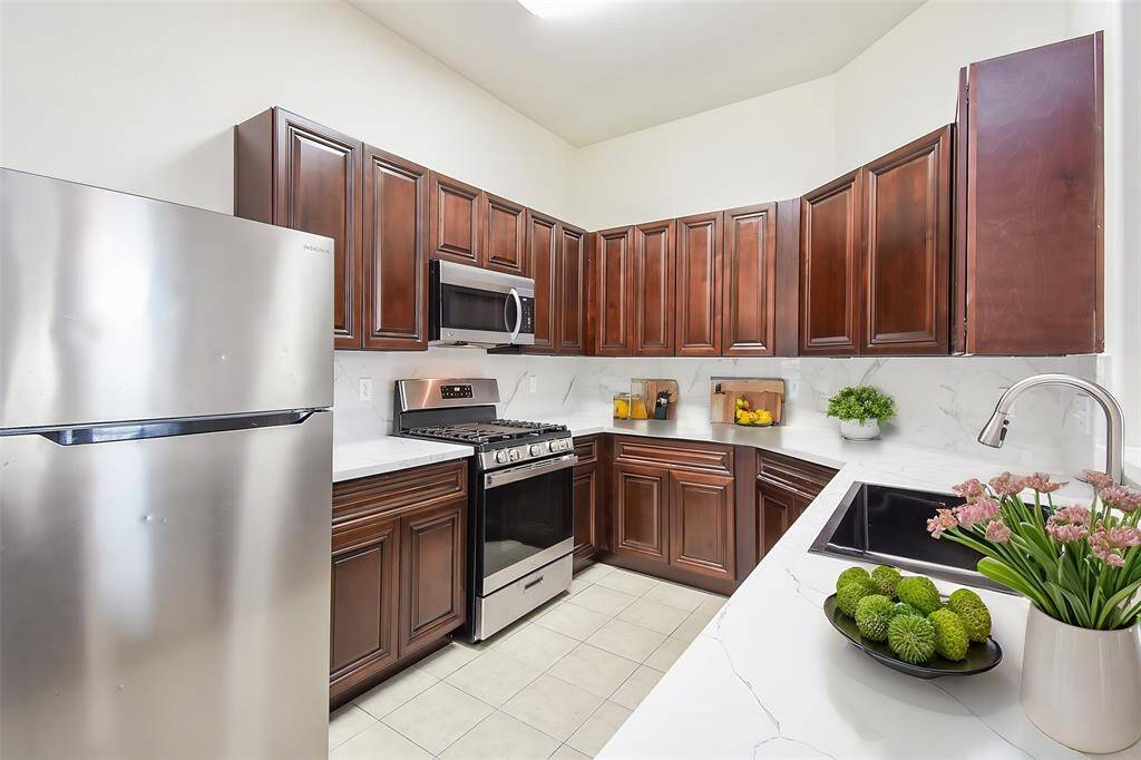 Beautiful dark wood cabinets provide ample storage and add a touch of elegance to the space.
